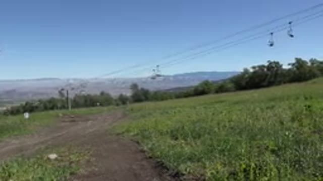 MESA COLORADO-2016: A Big Hill Covered In Grass With A Ski Lift Going Up And