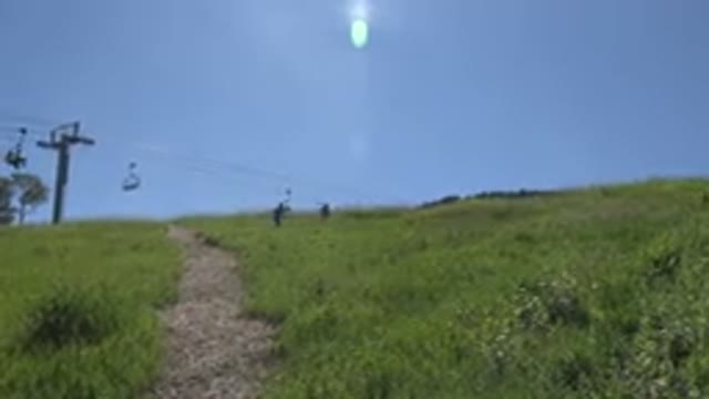 MESA COLORADO-2016: People Hike Up A Mountain With Ski Lifts In The Background