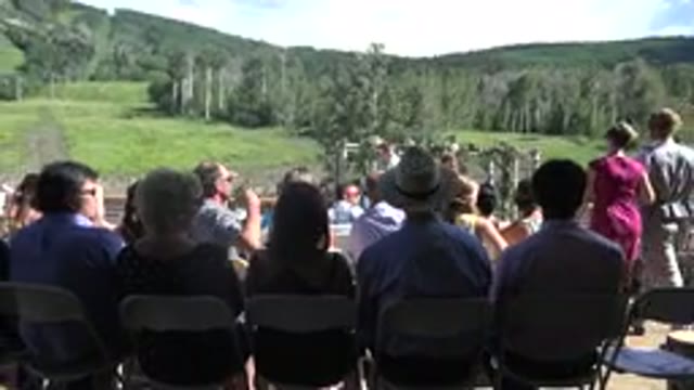 MESA COLORADO-2016: In A Vast Green Field There Are Several People Sitting In