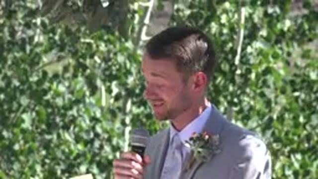 MESA COLORADO-2016: Man Wearing Grey Suit Talks Into Microphone On A Sunny Day