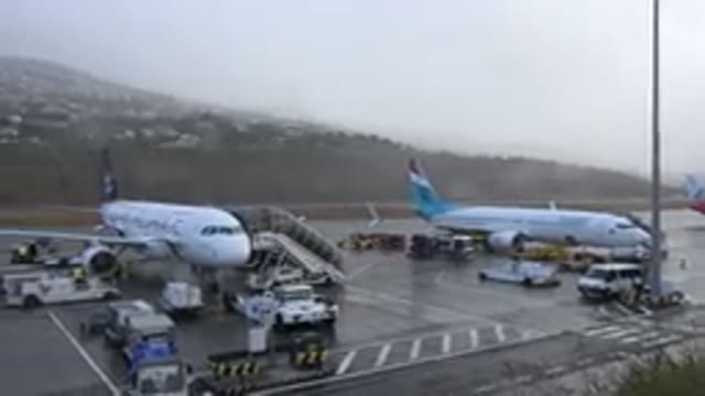 MADIERA PORTUGAL-2016: Airport Showing Planes At The Terminal And Baggage Carts