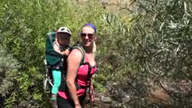 GOLDEN COLORADO-2016: Woman Standing Outside In The Nature Holding Child In Carrier