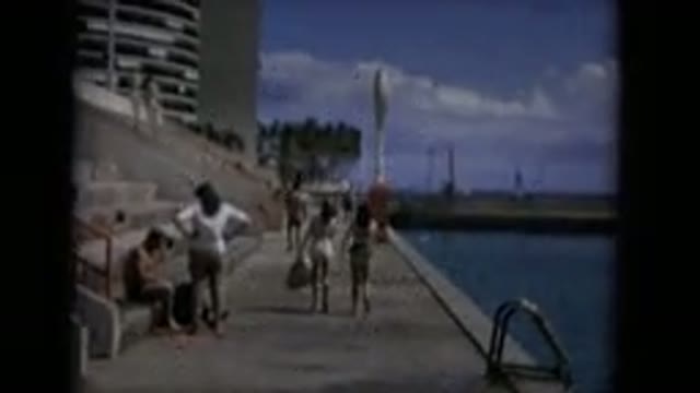 KEENESBURG COLORADO-2016: People Walking In Swimsuits On Seawall With Palms