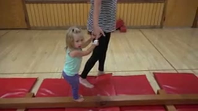 WESTMINSTER COLORADO-2016: Woman Wearing Black Pants Helps Girl Wearing Green