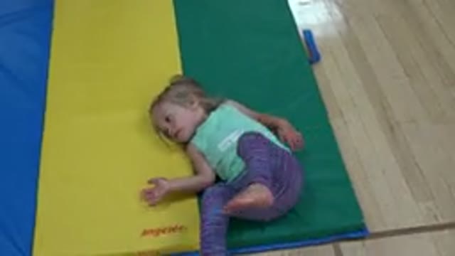 WESTMINSTER COLORADO-2016: A Little Girl With Blue Top And Blue Trousers Is Rolling On Mat