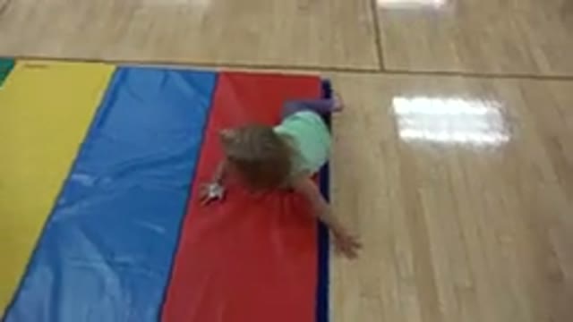 WESTMINSTER COLORADO-2016: A Little Girl Crawling On A Multi Colored Mat In A