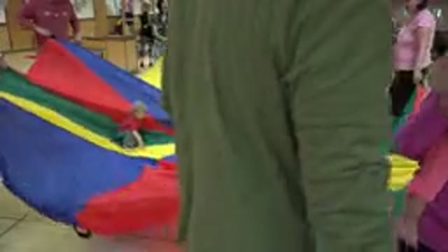 WESTMINSTER COLORADO-2016: Parents Playing With Their Children On A Large Sheet