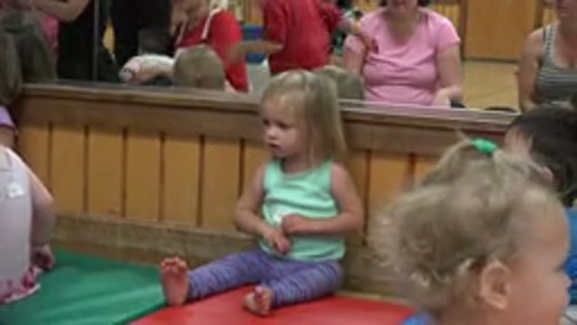 WESTMINSTER COLORADO-2016: Young Girl Sits in Play Area with Other Children