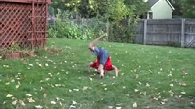 WESTMINSTER COLORADO-2016: A Young Boy Plays Joyfully in a Backyard