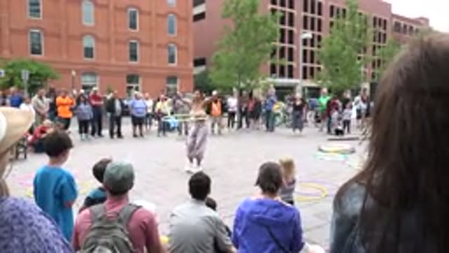 GRAND JUNCTION COLORADO-2017: Woman In A Plaza Doing Tricks With A Hula Hoop