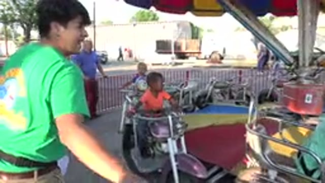 GRAND JUNCTION COLORADO-2017: Kids At An Amusement Park Riding On A Merry Go