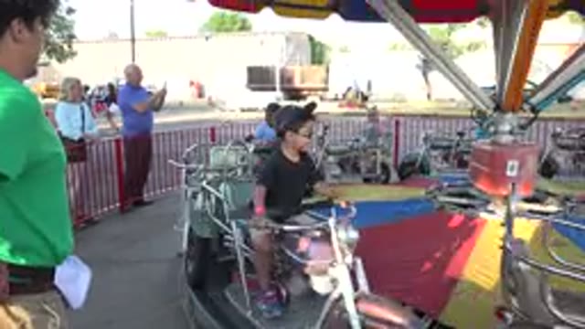 GRAND JUNCTION COLORADO-2017: Children Ride Bikes On Revolving Fairground Ride