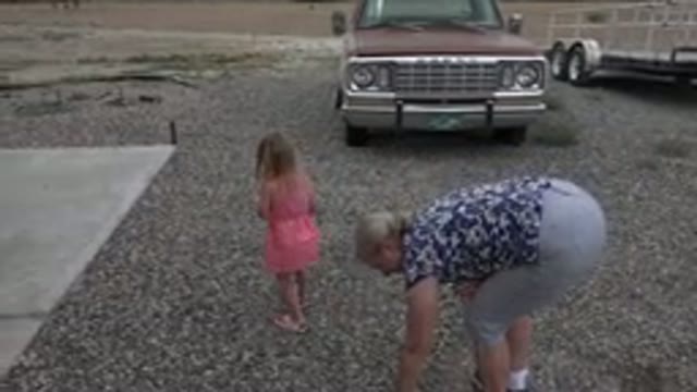 GRAND JUNCTION COLORADO-2017: Mother And Daughter In Gravel Driveway Looking For