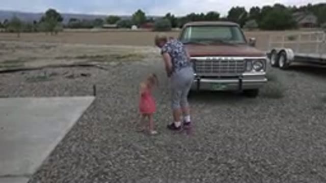 GRAND JUNCTION COLORADO-2017: Mom And Daughter Walking In A Driveway With Cars