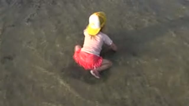 GRAND JUNCTION COLORADO-2017: Little Girl Playing At The Shore With A Shovel