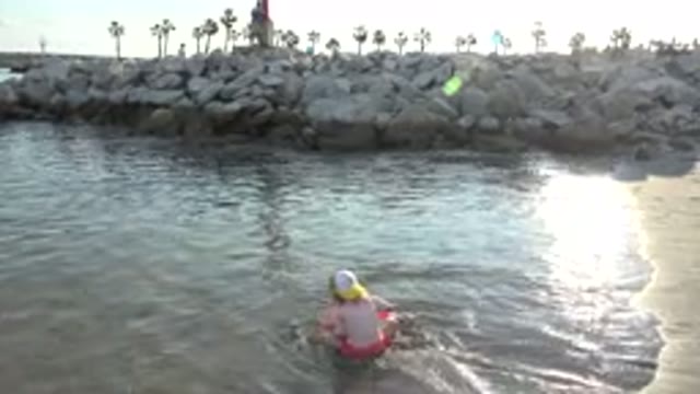 GRAND JUNCTION COLORADO-2017: Little Girl Sitting And Playing In The Water