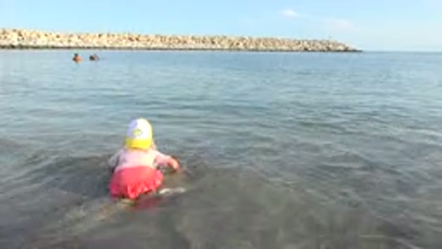 GRAND JUNCTION COLORADO-2017: Little Girl Playing At The Shore With Her Shovel