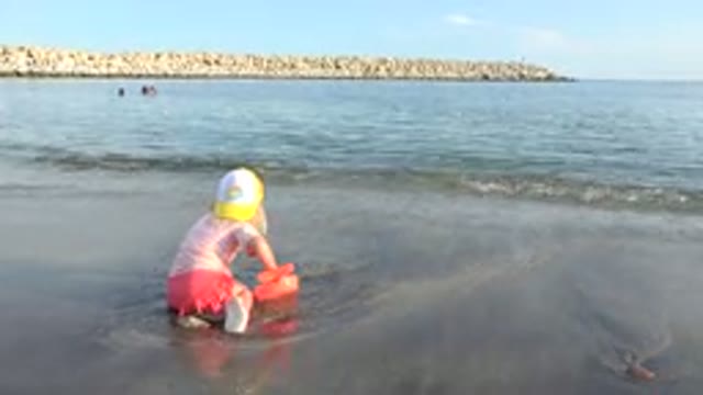 GRAND JUNCTION COLORADO-2017: Little Girl Plays Sand By The Shore