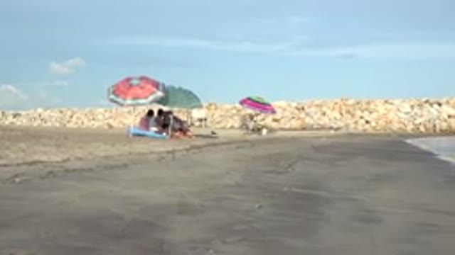 GRAND JUNCTION COLORADO-2017: People Sit Under The Umbrellas At The Beach On A