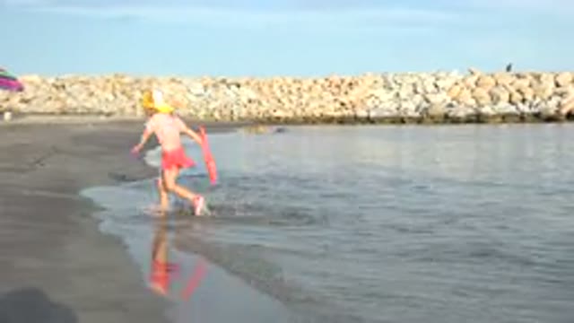 GRAND JUNCTION COLORADO-2017: A Lovely Girl Is Jumping Into Water At A Beach On