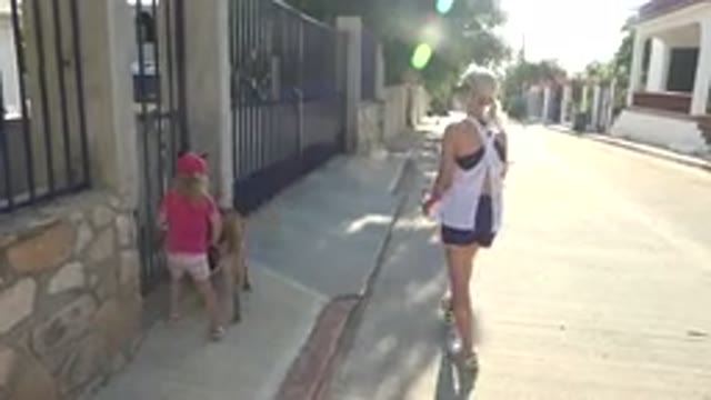 GRAND JUNCTION COLORADO-2017: Mom And Daughter Walking Down A Street With Houses