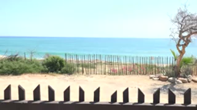 GRAND JUNCTION COLORADO-2017: Beach On A Sunny Day With Rocks Sand Sea Blue Sky