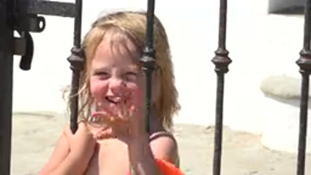 GRAND JUNCTION COLORADO-2017: Blond Smiling Child Holding Iron Gate Waving
