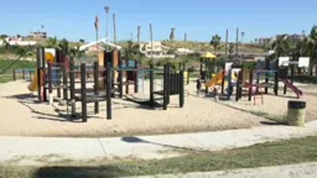 GRAND JUNCTION COLORADO-2017: A Wide Shot Of A Parent Kid And Dog On A Playground