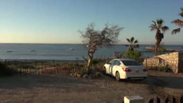 GRAND JUNCTION COLORADO-2017: White Car Parked Near The Pier With Waves Breaking