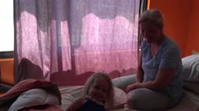GRAND JUNCTION COLORADO-2017: Woman Wearing Blue Shirt Smiles At Girl Wearing
