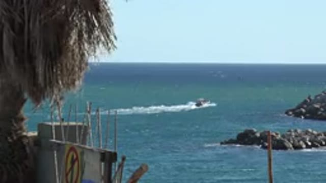 GRAND JUNCTION COLORADO-2017: Ocean Shore With Boat Motoring Out To Sea