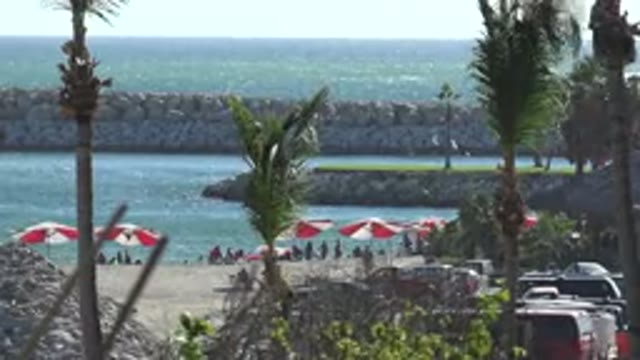 GRAND JUNCTION COLORADO-2017: A Group Of People Near The Beach With Umbrellas In