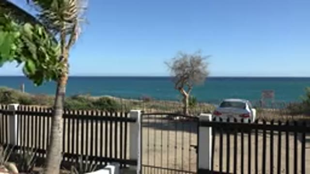 GRAND JUNCTION COLORADO-2017: Beach In A Sunny Day With Rocks Sand Sea Blue Sky