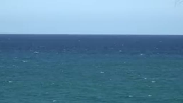 GRAND JUNCTION COLORADO-2017: Calm Blue-Green Ocean Water And Blue Sky On A