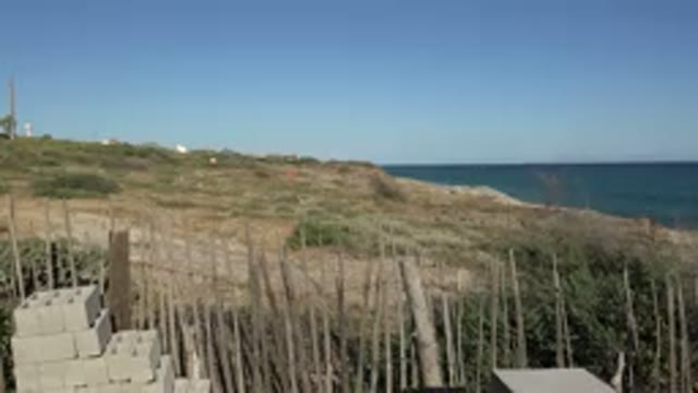 GRAND JUNCTION COLORADO-2017: Grassy Beach Dunes Overlooking A Dark Blue Ocean