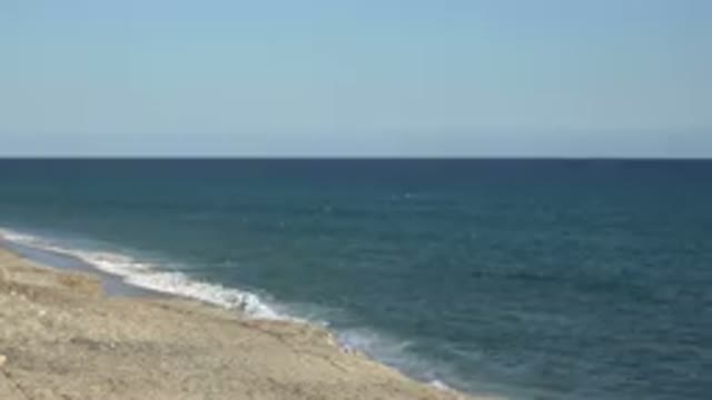 GRAND JUNCTION COLORADO-2017: A Quiet Beach Where Waves In Ocean Are Striking It