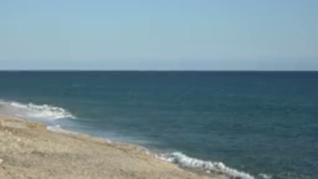 GRAND JUNCTION COLORADO-2017: The Waves From The Blue Ocean Lap The Shore And It