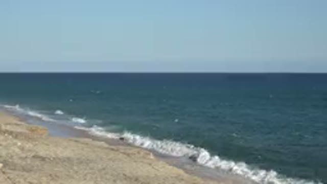 GRAND JUNCTION COLORADO-2017: A Sunny Day On Beach With Waves Of Ocean Striking