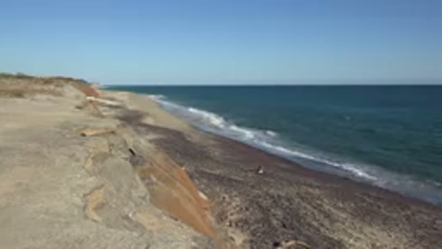 GRAND JUNCTION COLORADO-2017: Beach To The Left Ocean Waves Rush Onto Shore On
