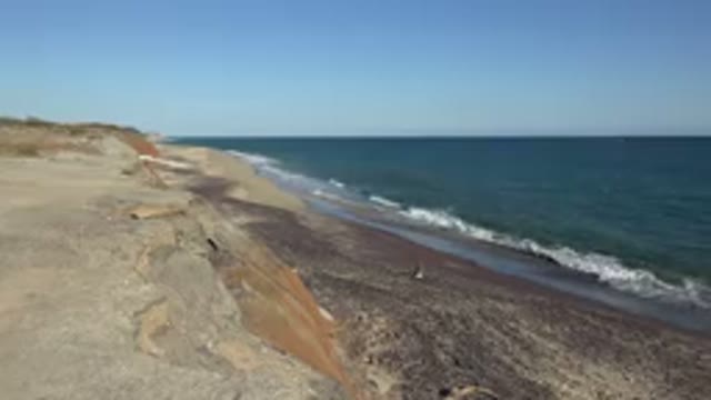 GRAND JUNCTION COLORADO-2017: Dark Stony Beach Being Hit By Sea Water