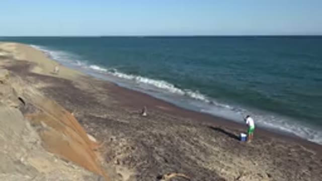 GRAND JUNCTION COLORADO-2017: Person Standing On Beach As Waves Roll In To Shore