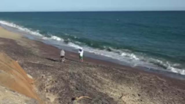 GRAND JUNCTION COLORADO-2017: Two People Walking Along The Beachfront