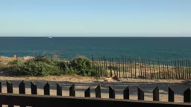GRAND JUNCTION COLORADO-2017: Blue Ocean Water And Green Bush On A Clear Sunny Day