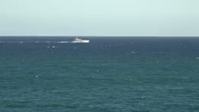 GRAND JUNCTION COLORADO-2017: A Shot Of The Ocean With A Boat Driving By