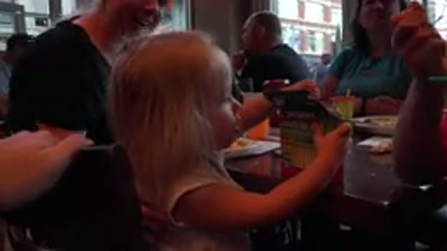 DENVER COLORADO-2016: Little Girl Enjoying Her First Visit To The Restaurant