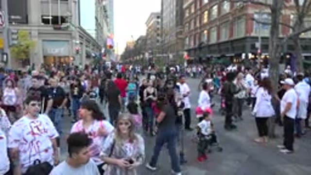 DENVER COLORADO-2016: Large Crowd Walking Through City Streets On A Clear Day