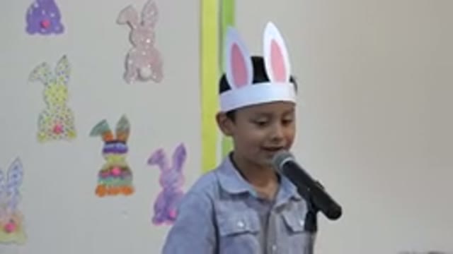 CABO SAN LUCAS MEXICO-2019: Asian Child With Rabbit Ears Cap Speaking On Microphone