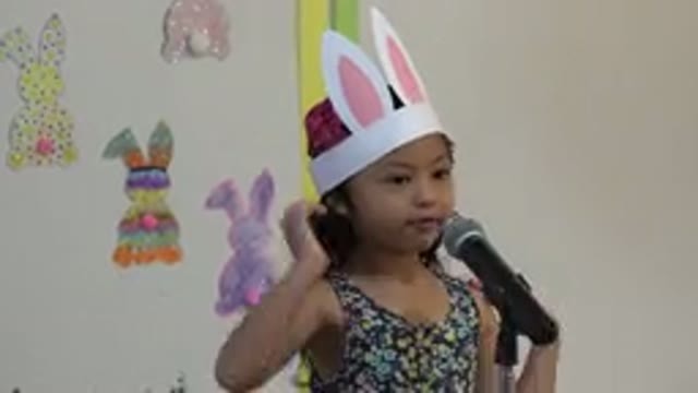 CABO SAN LUCAS MEXICO-2019: A Little Girl With Bunny Ears Speaking Into A Microphone
