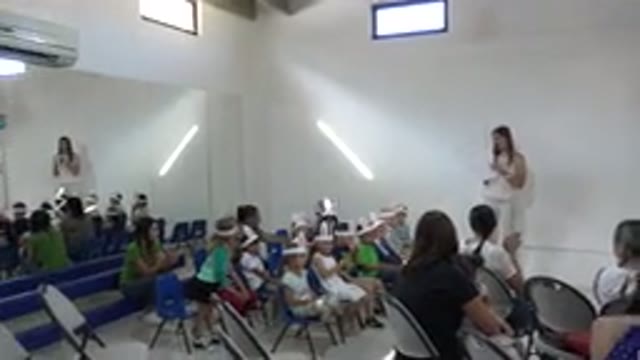 CABO SAN LUCAS MEXICO-2019: Woman Wearing White Shirt Points To Kids Sitting In