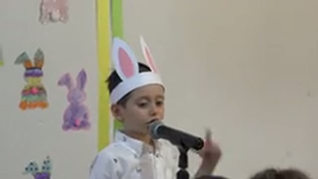 CABO SAN LUCAS MEXICO-2019: Child Speaking Into Microphone While Wearing Paper Bunny Costume